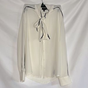 Sheer white blouse with black detail and a tie neck